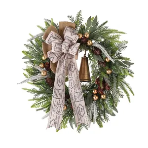 Christmas wreath with pine cones, golden balls, rustic bells, and Merry Christmas bow