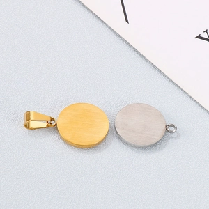 Close-up of gold and silver round stainless steel watch pendant blanks for DIY jewelry