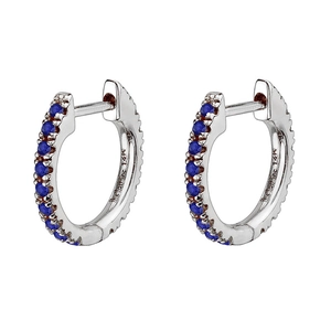 Detail of 14k gold huggie earrings featuring a row of round-cut blue zircon gemstones