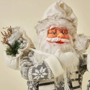 Nordic Santa Claus figure in grey sweater holding a gift bag and lantern for Christmas