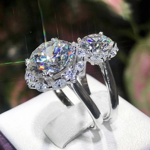 Sparkling silver couple wedding rings with round-cut moissanite stones and halo setting