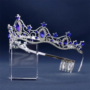 Macro detail of silver bridal crown with faceted deep blue and clear rhinestones