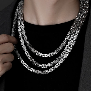 Close-up of triple layered silver Byzantine chains with high-quality polished steel finish
