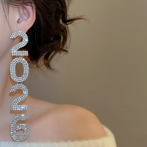 Close-up of 2026 number tassel earrings with sparkling rhinestones on model ear