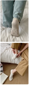 Close-up of beige polka dot low-cut invisible socks with breathable knit texture