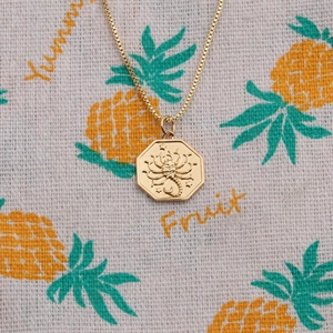 Octagon gold pendant necklace featuring a detailed scorpion relief on a box chain