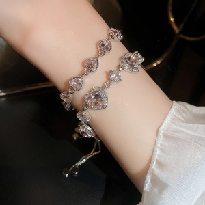 Elegant silver adjustable pull-chain bracelet featuring double pink heart-shaped crystals