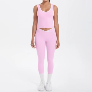 Detail of pink yoga set with V-shaped cross high waist leggings and contrast trim top