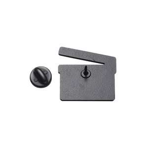 Detail view of the metal movie clapperboard pin back and secure black rubber clutch