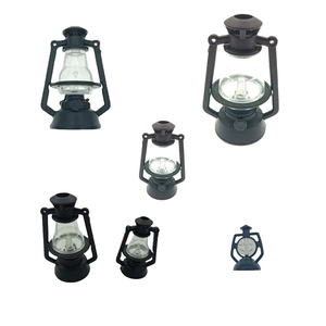 Set of six black vintage decorative plastic oil lamps in various sizes on white background