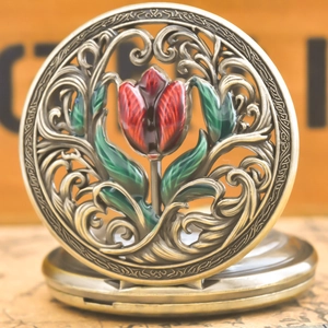 Macro detail of vintage bronze pocket watch featuring openwork and red tulip enamel