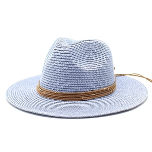 Wide brim woven sun hat in light blue with leather cord and golden bead decoration