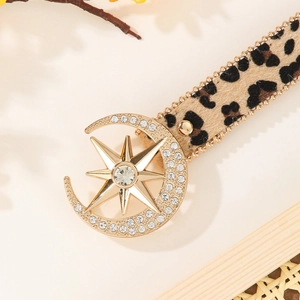 Leopard print leather belt with crystal-studded gold moon and star buckle closure