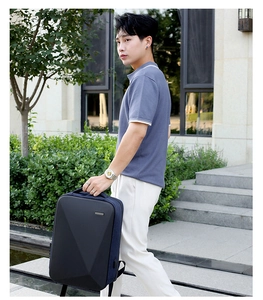 Modern geometric hard shell backpack shown in outdoor business city commute setting