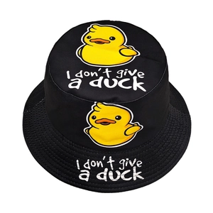 Black cotton bucket hat with yellow duck print and slogan on a white background