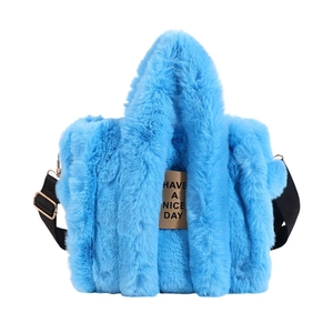 Detail of blue faux fur tote bag showing the plush texture and Have a Nice Day leather label