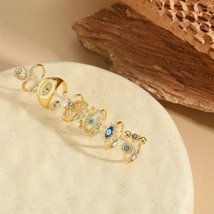 Set of six gold-plated bohemian rings featuring blue evil eye and butterfly motifs