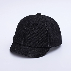 Detailed close-up of a black denim baby baseball cap with a short brim and retro style