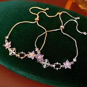 Macro detail of adjustable flower sliders bracelets with purple zircon and dark gemstones