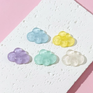 Five translucent resin cloud charms in pastel colors displayed on white stone base