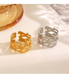 Detail of 18K gold plated and silver stainless steel woven rings with small beads