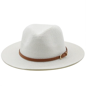 Detail of white straw hat showing fine weave texture and brown band with gold buckle