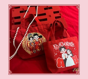 Detail of red wedding canvas gift bags featuring cartoon bride and groom illustrations