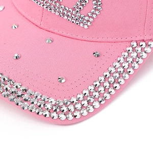 Close-up detail of handcrafted pink denim baseball cap with premium rhinestone embellishment