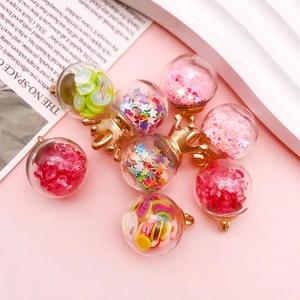 Detailed view of colorful glass pendants with fruit slices and sequins for DIY jewelry