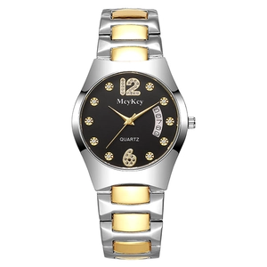 Detail of classic two-tone watch face featuring sparkling rhinestones and a date window