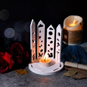 Macro detail of white hollowed-out candle holder with animal and nature patterns