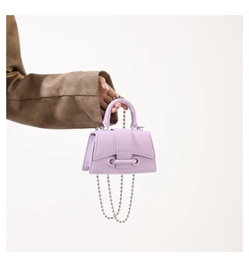 Detailed macro of lavender mini tote bag with silver beaded chain and lychee texture