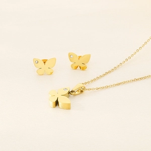 Detailed view of gold butterfly jewelry set featuring sparkling crystals on necklace and studs