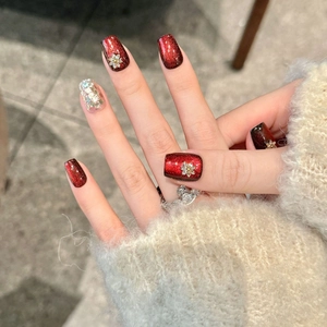 Handmade burgundy cat eye press-on nails with silver glitter and golden floral accents