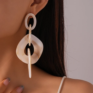 Close-up of three interlocking acrylic marble hoops with steel posts on model