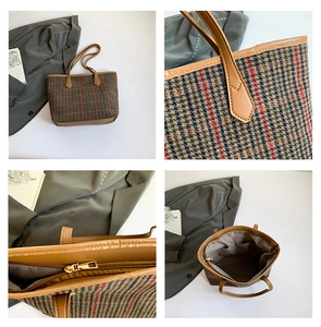 Detail view of large plaid tote showing tweed texture, leather handles, and inner pockets