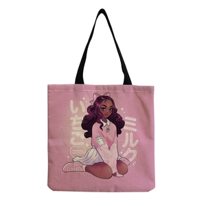 Detail of pink canvas tote bag with anime girl print and black shoulder straps