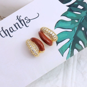 Retro golden C-shape earrings with reddish brown enamel and shimmering zircon stones