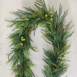 Detail view of Norfolk pine garland with realistic greenery and small green berry clusters