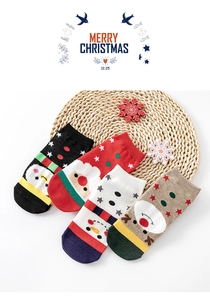 Detailed view of four pairs of cotton Christmas socks with festive holiday patterns