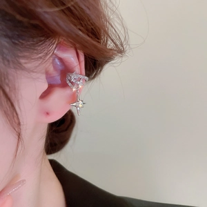 Detail of silver star tassel ear cuff with shimmering zircon and opal on a model