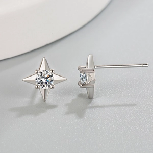 Minimalist four-pointed star stud earrings with central cubic zirconia in silver finish