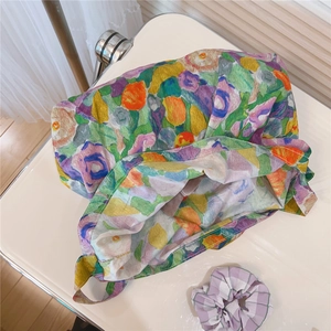 Detail of floral canvas tote bag with vibrant oil painting print and purple checkered scrunchie