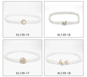 Detail view of pearl waist belts featuring butterfly and flower rhinestone buckles