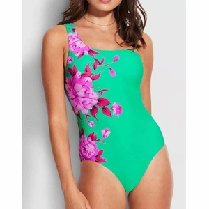 Detail of green one-shoulder swimsuit with deep pink and purple floral patterns