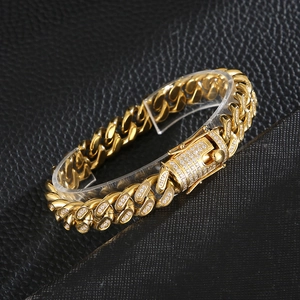 Detailed macro view of gold plated Cuban link bracelet with square buckle and zircon stones