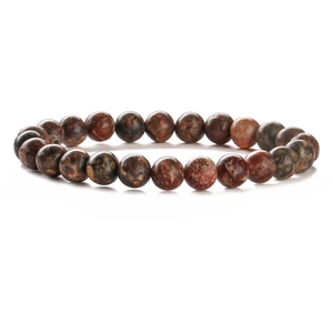 Macro detail of natural stone beaded bracelet showing unique leopard jasper textures
