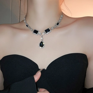 Detail view of a vintage geometric necklace with black teardrop crystals and silver diamonds
