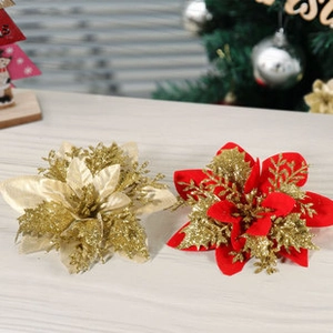 Close-up of glittery red and gold artificial poinsettia flowers for Christmas decor