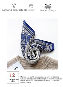 Detail of 12 momme silk scarf with blue Toile de Jouy print on a beige sweater